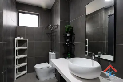 a bathroom with a white sink and a toilet at Astoria Ampang in Kuala Lumpur