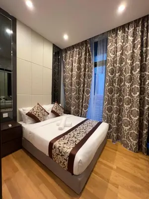 a bedroom with a bed and a window with curtains at Dorsett Residence Service Suite At Bukit Bintang KL in Kuala Lumpur