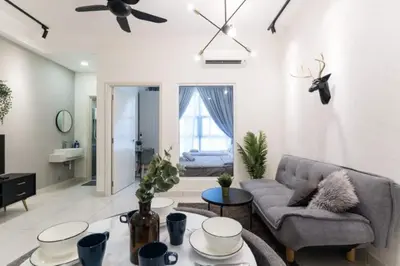 a living room with a couch and a table at Arte Mont Kiara 3pax Jacuzzi Pool Gym near MITEC Matrade in Kuala Lumpur