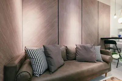 a couch with pillows on it in a living room at Arte Mont Kiara 3pax Jacuzzi Pool Gym near MITEC Matrade in Kuala Lumpur
