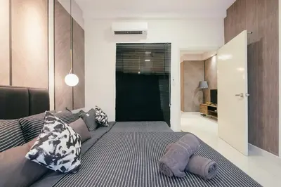 a bedroom with a large bed with at Arte Mont Kiara 3pax Jacuzzi Pool Gym near MITEC Matrade in Kuala Lumpur