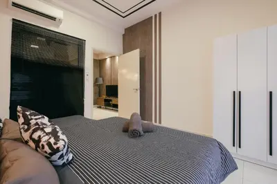 a bedroom with a bed with a stuffed animal on it at Arte Mont Kiara 3pax Jacuzzi Pool Gym near MITEC Matrade in Kuala Lumpur