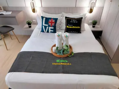a hotel room with a bed with two pairs of socks at Continew Residence by HomeBrickz in Kuala Lumpur