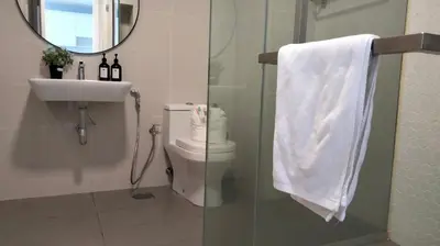 a bathroom with a toilet and a sink and a mirror at Continew Residence by HomeBrickz in Kuala Lumpur