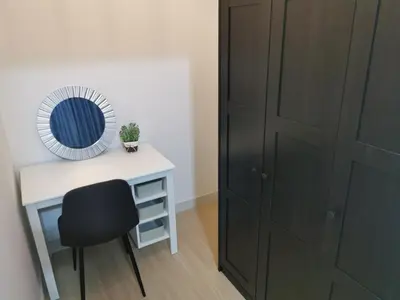 a desk with a mirror and a chair next to a closet at Continew Residence by HomeBrickz in Kuala Lumpur