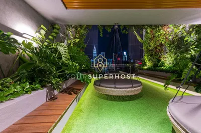 an indoor garden with a bench and plants at Ceylonz Suites nr Pavilion & KLCC by YourSuperhost in Kuala Lumpur