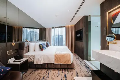 a bedroom with a bed and a large window at WOLO Kuala Lumpur in Kuala Lumpur
