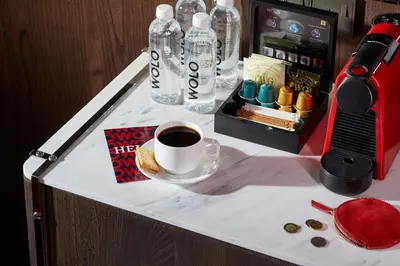 a table with a bottle of water and a cup of coffee at WOLO Kuala Lumpur in Kuala Lumpur