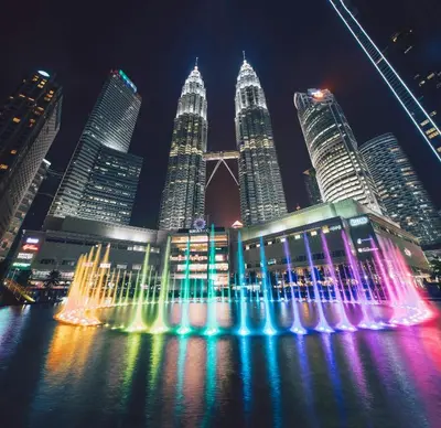 a fountain in front of a city at night at WOLO Kuala Lumpur in Kuala Lumpur