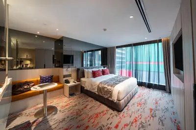 a hotel room with a bed and a large window at WOLO Kuala Lumpur in Kuala Lumpur