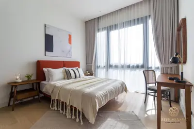 a bedroom with a bed and a desk and a window at ViiA Residences Kuala Lumpur, Five Senses in Kuala Lumpur