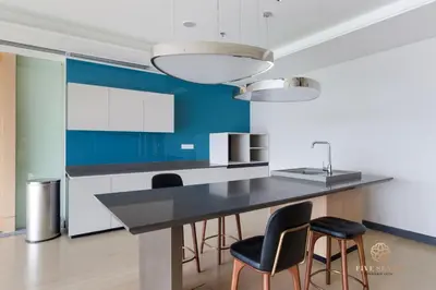a kitchen with a black counter and chairs at ViiA Residences Kuala Lumpur, Five Senses in Kuala Lumpur