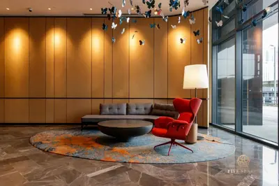 a living room with a couch and a red chair at ViiA Residences Kuala Lumpur, Five Senses in Kuala Lumpur