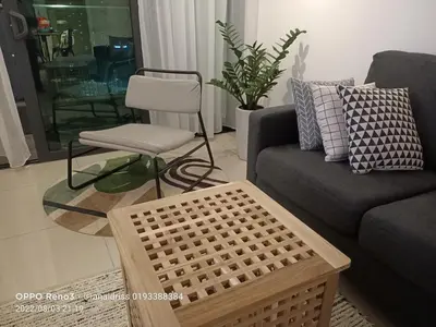 a living room with a couch and a chair at Legasi Kampung Baru apartment by rumahrehat in Kuala Lumpur