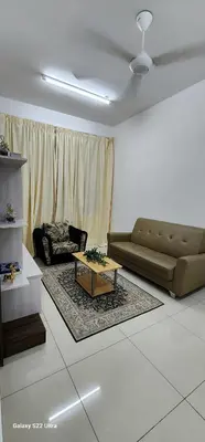 a living room with a couch and a coffee table at Legasi Kampung Baru apartment by rumahrehat in Kuala Lumpur