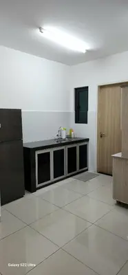 a room with a kitchen with a table and a counter at Legasi Kampung Baru apartment by rumahrehat in Kuala Lumpur