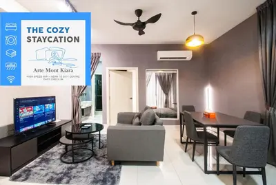 a living room with a tv and a couch and a table at Nj Homestay at Arte Mont Kiara in Kuala Lumpur