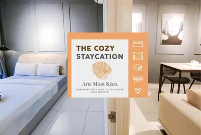 a sign in a room with a bed and a table at Nj Homestay at Arte Mont Kiara in Kuala Lumpur