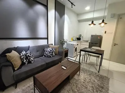 a living room with a couch and a table at Nj Homestay at Arte Mont Kiara in Kuala Lumpur