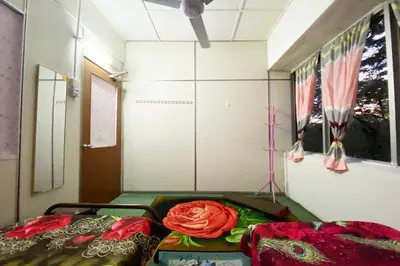 a room with two beds and a window at Hotel O Syariah Asam Pedas in Kuala Lumpur