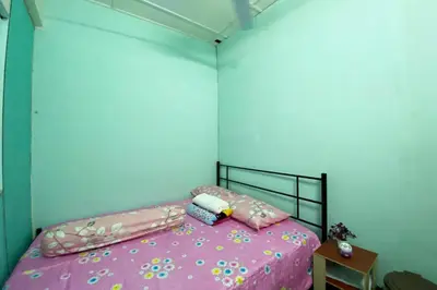 a bedroom with a pink bed with pink sheets at Hotel O Syariah Asam Pedas in Kuala Lumpur
