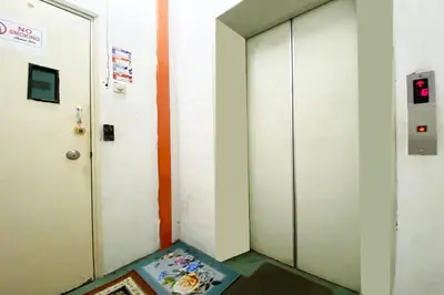 a corridor with a door and a mat in front of it at Hotel O Syariah Asam Pedas in Kuala Lumpur