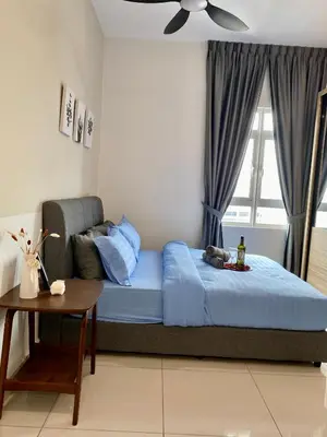 a bedroom with a bed with blue sheets and a window at TR Residence Near Titiwangsa LRT By Iconique in Kuala Lumpur