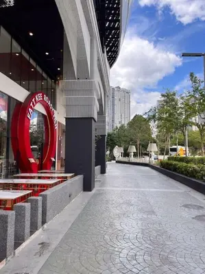 a building with a red sign on the side of a street at Modern Suites at Arte Mont Kiara BY Iconique in Kuala Lumpur