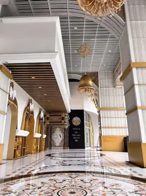 a building with a lobby with a clock on the wall at Modern Suites at Arte Mont Kiara BY Iconique in Kuala Lumpur