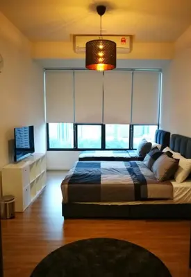 a bedroom with a bed and a large window at Ceylonz Suite Official in Kuala Lumpur