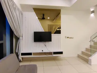 a living room with a flat screen tv on a wall at M City 2 DUPLEX BEDROOM KLCC in Kuala Lumpur
