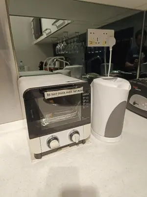 a toaster oven sitting on a counter in a kitchen at KLCC Gem walk to all in Kuala Lumpur