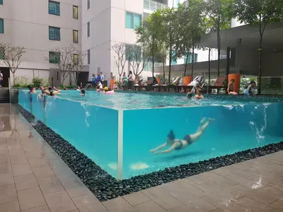 a group of people swimming in a swimming pool at KLCC Gem walk to all in Kuala Lumpur