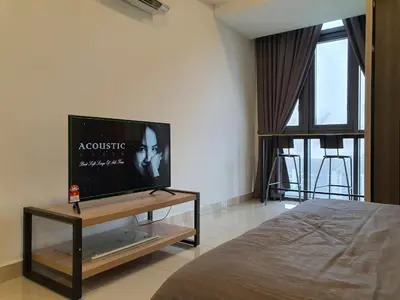 a bedroom with a flat screen tv on a table at Vivo Soho Suite @ Mid Valley Old Klang Road KL in Kuala Lumpur