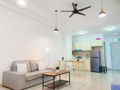 a living room with a couch and a kitchen at Vivo Soho Suite @ Mid Valley Old Klang Road KL in Kuala Lumpur