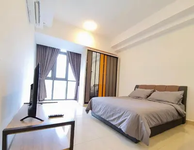 a bedroom with a bed and a television on a desk at Vivo Soho Suite @ Mid Valley Old Klang Road KL in Kuala Lumpur