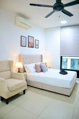 a bedroom with a bed and a couch and a ceiling fan at New Arcoris 6 Pax 2 BR with Pool View Mont Kiara - BOHO in Kuala Lumpur