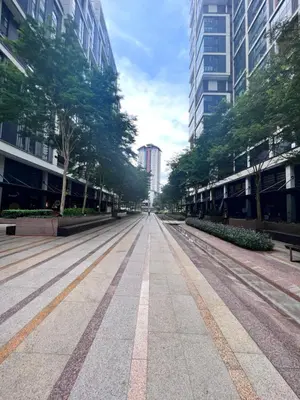 an empty street in a city with tall buildings at New Arcoris 6 Pax 2 BR with Pool View Mont Kiara - BOHO in Kuala Lumpur