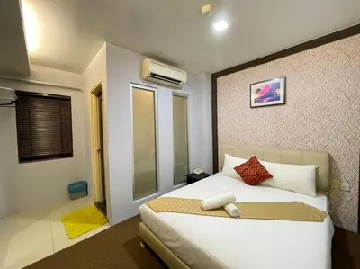 a bedroom with a large white bed in a room at Rae Hotel Bukit Bintang in Kuala Lumpur