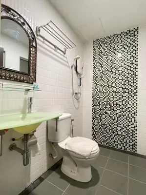 a bathroom with a toilet and a sink and a shower at Rae Hotel Bukit Bintang in Kuala Lumpur
