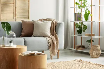 a living room with a couch with a book on it at Arte City View by Sweethost in Kuala Lumpur