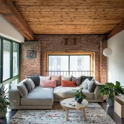 a living room with a couch and a brick wall at Arte City View by Sweethost in Kuala Lumpur