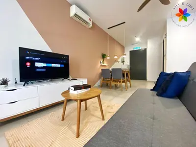 a living room with a flat screen tv and a table at Lily and Loft - Queensville @ Kuala Lumpur - Netflix in Kuala Lumpur