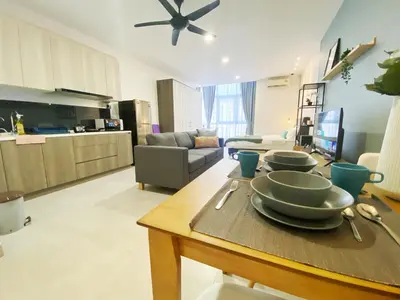 a living room with a table with plates on it at Lily and Loft - Queensville @ Kuala Lumpur - Netflix in Kuala Lumpur