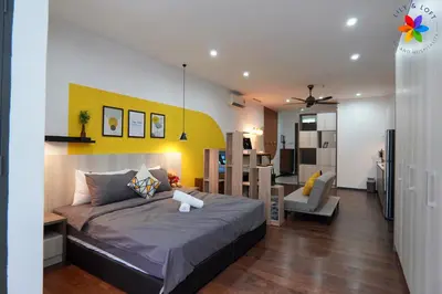 a bedroom with a bed and a living room at Lily and Loft - Queensville @ Kuala Lumpur - Netflix in Kuala Lumpur