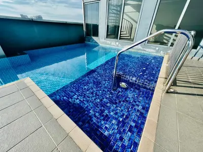 a swimming pool with blue tiles on a house at 3 Towers Klcc By Tenang Homes in Kuala Lumpur