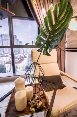 a room with a table with candles and a plant at 3 Towers Klcc By Tenang Homes in Kuala Lumpur