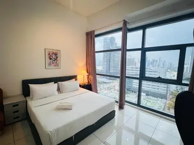 a bedroom with a bed and a large window at 3 Towers Klcc By Tenang Homes in Kuala Lumpur