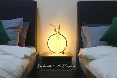 a mirror on a night stand next to two beds at Modern Suites 3Beds at Continew, TRX KLCC view, Next to IKEA in Kuala Lumpur