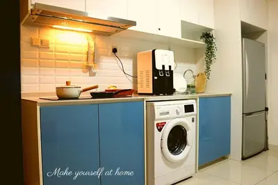 a kitchen with a washing machine on a counter at Modern Suites 3Beds at Continew, TRX KLCC view, Next to IKEA in Kuala Lumpur